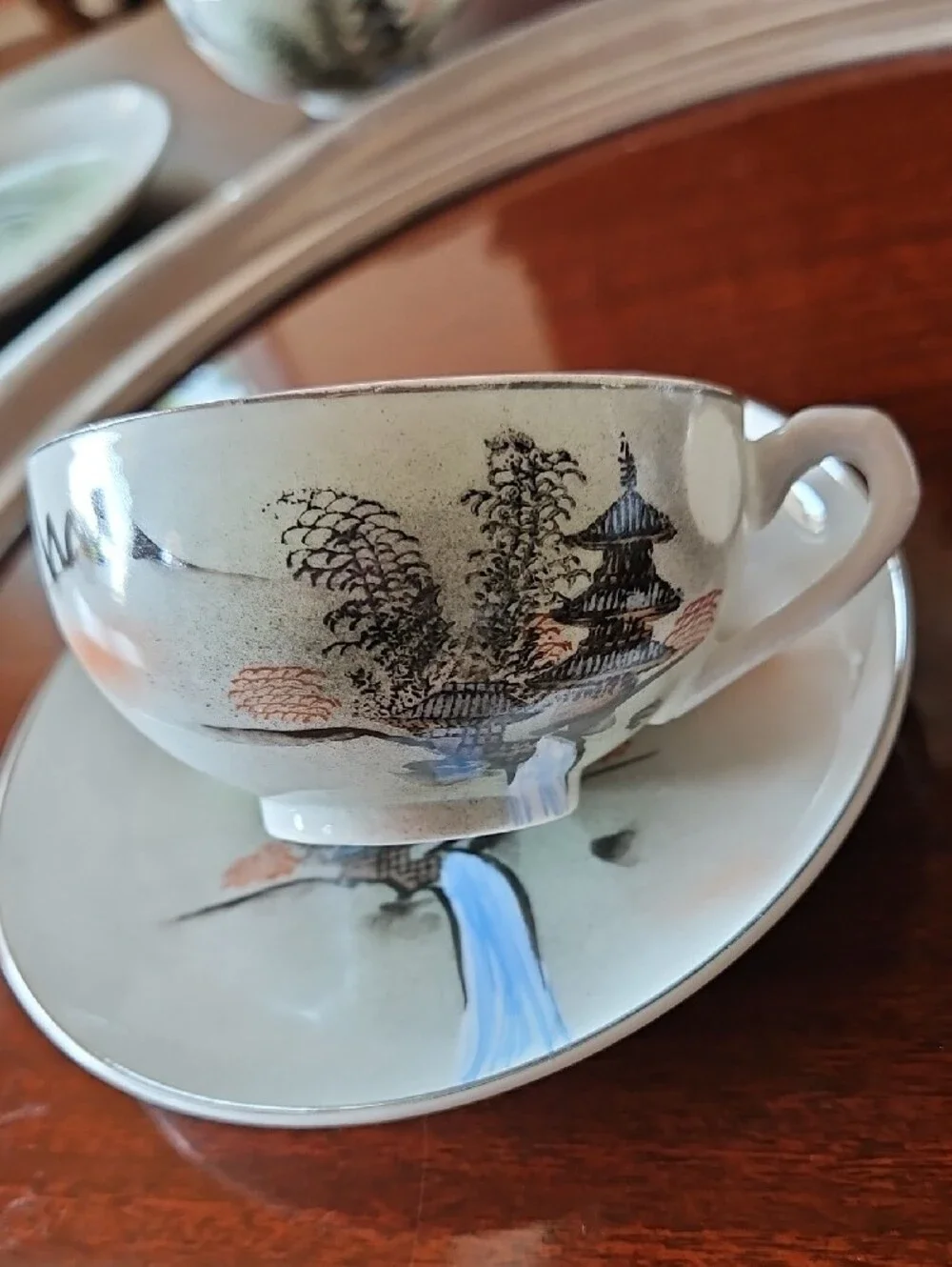 Vintage Porcelain Teacup & Saucer Set in White with Blue and Tan Accents